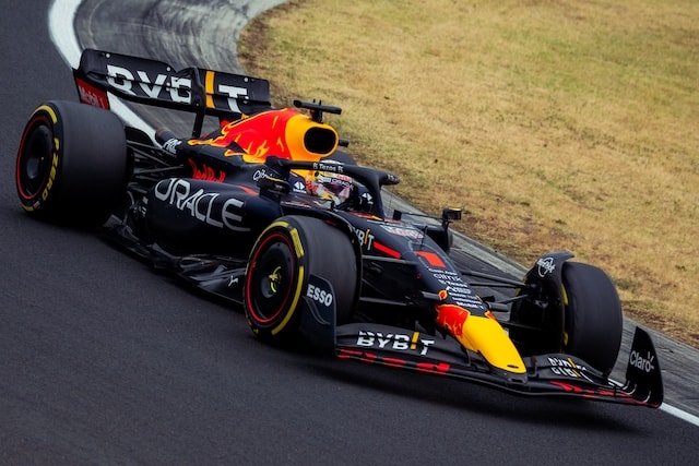 Max Verstappen on track in his Red Bull F1 car going round a corner at high speed.