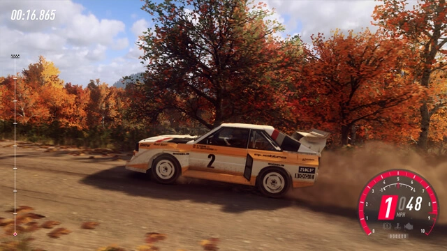 Dirt Rally 2.0 game with Audi Quattro rally car racing on a dirt course with autumn trees in the background.