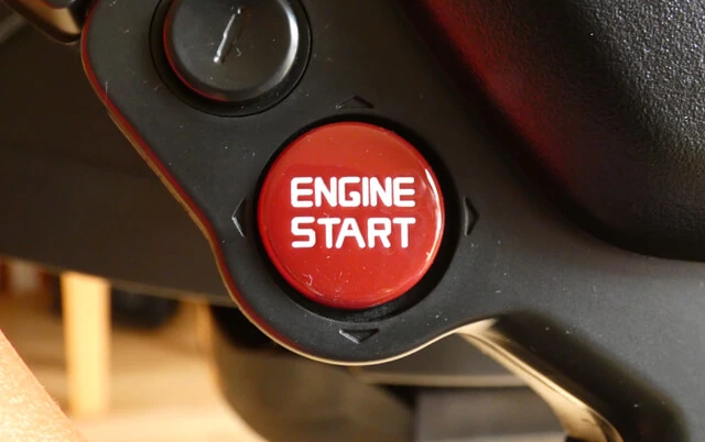 Thrustmaster Ferrari 458 Spider beginner sim racing wheel showing the red Engine Start button.