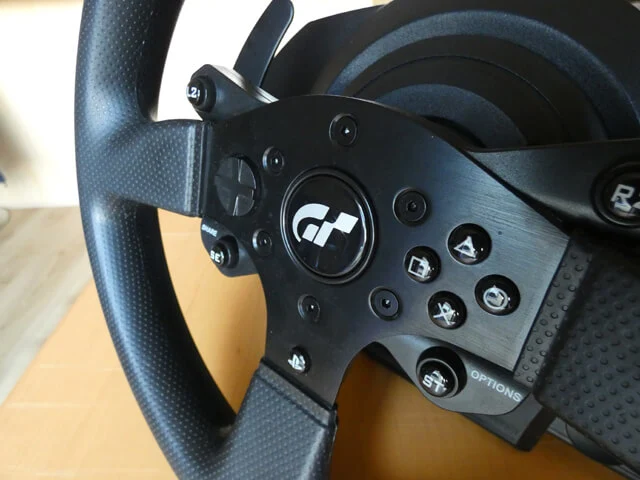 Thrustmaster T300 RS GT Edition sim racing wheel showing the front face buttons.