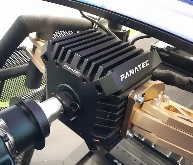 Fanatec CSL DD direct drive wheel base attached to a Rennsport Cockpit V2 with the Podium Mounting Brackets, with the CSL pedals in the background.