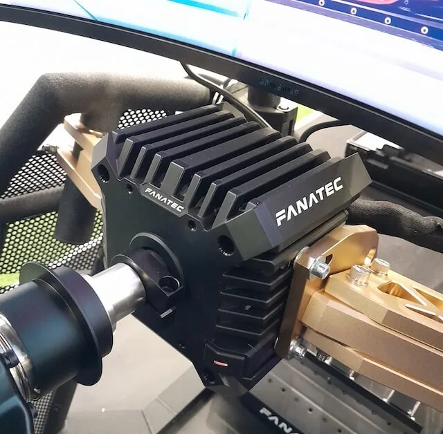 Fanatec CSL DD sim racing wheel base mounted to a Rennsport V2 cockpit using Podium Brackets with CSL pedals in the background.