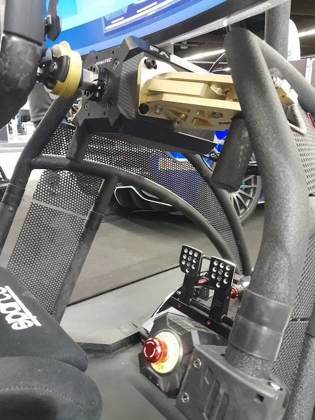 Fanatec DD2 direct drive sim racing wheel base mounted to a Rennsport V2 cockpit with Fanatec ClubSport V3  pedals, showing the emergency stop button for the wheel base.