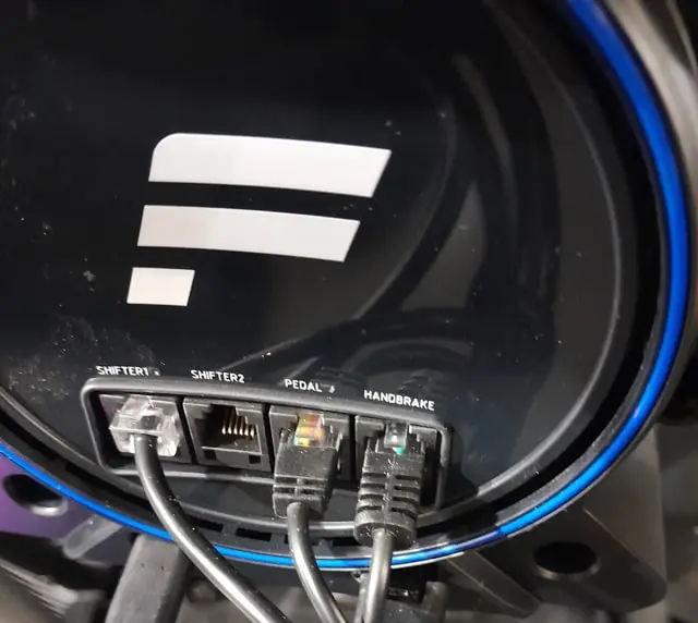 Back of the Fanatec Gran Turismo DD Pro sim racing wheel base showing the ports for shifter, pedal and handbrake connections.