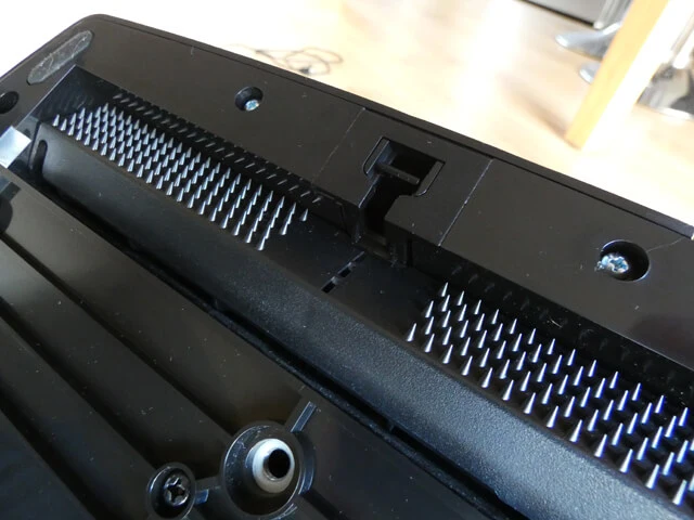 Logitech G29 sim racing pedal base showing the retractable carpet spikes.