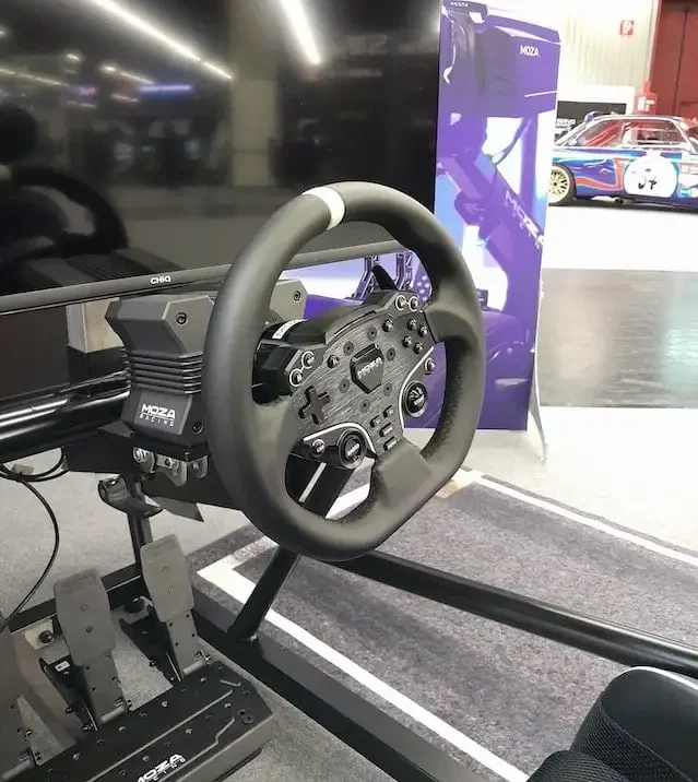 MOZA R5 sim racing wheel base, ES wheel rim and SR-P Lite pedals set up and mounted with a monitor.