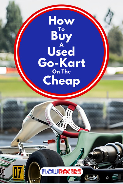 Tony Kart racing go-kart chassis sitting on a stand with a go-kart track in the background, How To Buy A Used Go-Kart On The Cheap