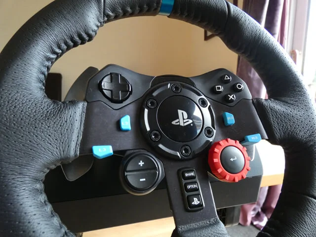 Logitech G29 sim racing wheel rim showing all the buttons on the front of the wheel.