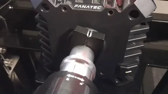 Close up of the Fanatec CSL DD wheel base showing the C-clamp that holds the shaft to the base itself.