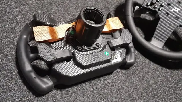 Fanatec CSL Elite McLaren GT3 wheel rim on a gray background next to the P1 V2 wheel rim.