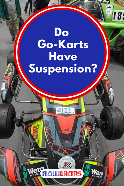 Red, black and yellow racing go-kart on a stand showing the lack of suspension, Do Go-Karts Have Suspension?