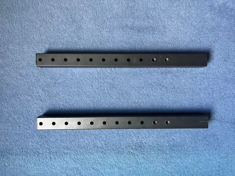 2 spare brackets not in use on the Next Level Racing monitor stand on a blue background.